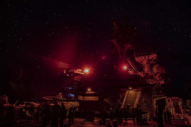 Sailors on the USS George H.W. Bush stargaze on the flightdeck.