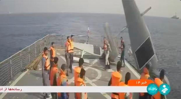 Iranian navy sailors throw an American sea drone overboard in the Red Sea