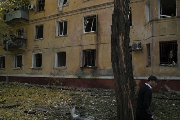 A man walks past a damaged building after a Russian attack in Kramatorsk, Ukraine