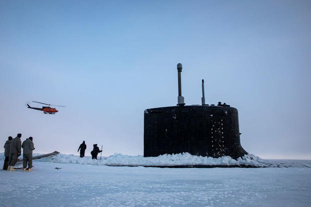 The Virginia-class fast attack submarine USS Illinois (SSN 786) moors to Arctic sea ice