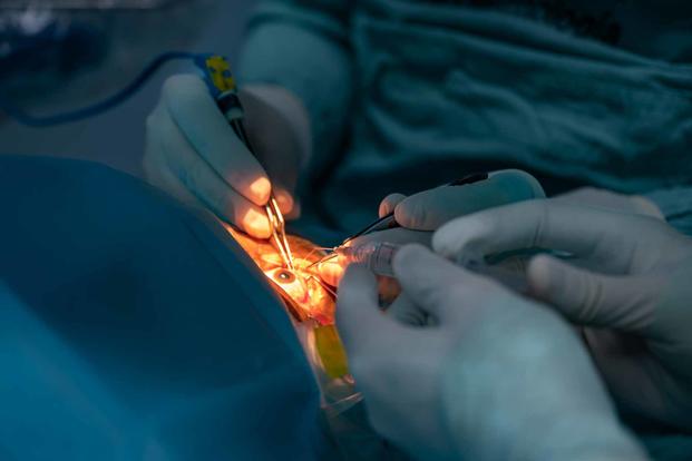 An Air Force ophthalmologist performs eye surgery.