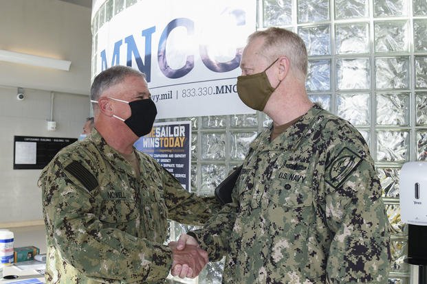 Vice Adm. John B. Nowell, the Chief of Naval Personnel (CNP), is greeted by Rear Adm. Stuart Satterwhite, commander, MyNavy Career Center (MNCC), at the entrance to the Capodanno building located aboard Naval Support Activity Mid-South.