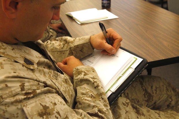 Sgt. Jacob Caudle, a rifleman with Company D, Anti-Terrorism Battalion, 4th Marine Division, absorbs information while attending a briefing on career options available to him as his infantry company is being transformed into a military police company in Billings, Montana.
