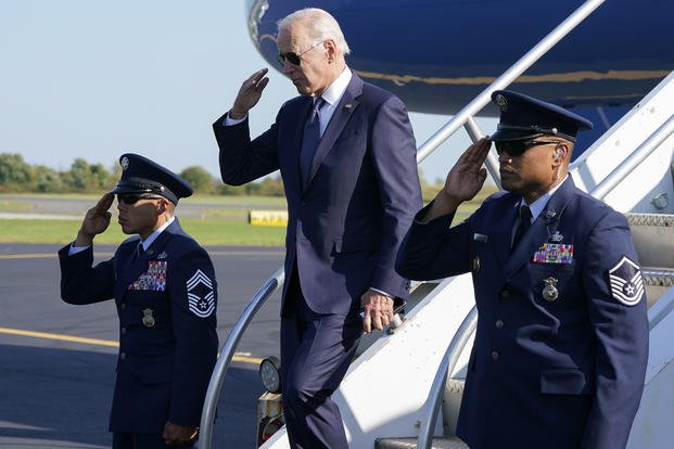 President Biden returns a salute as he exits Air Force One at Philadelphia International Airport.