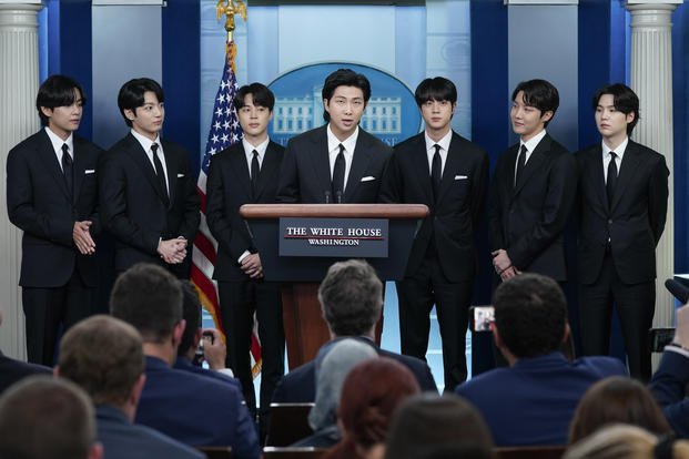 RM, center, accompanied by other K-pop supergroup BTS members from left, V, Jungkook, Jimin, Jin, J-Hope, and Suga