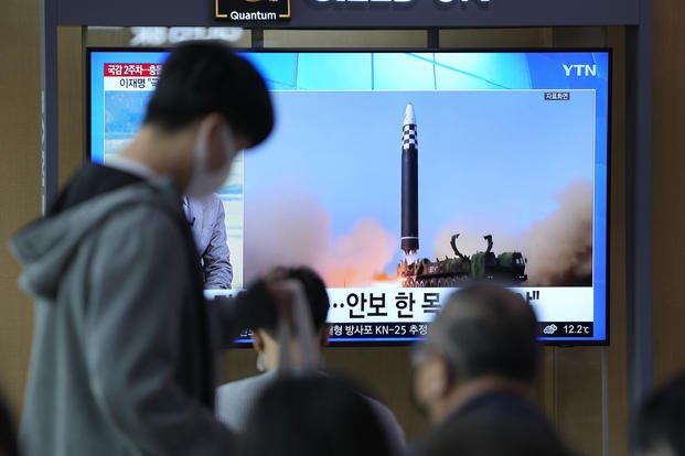 A TV screen showing a news program reporting about North Korea's missile launch.