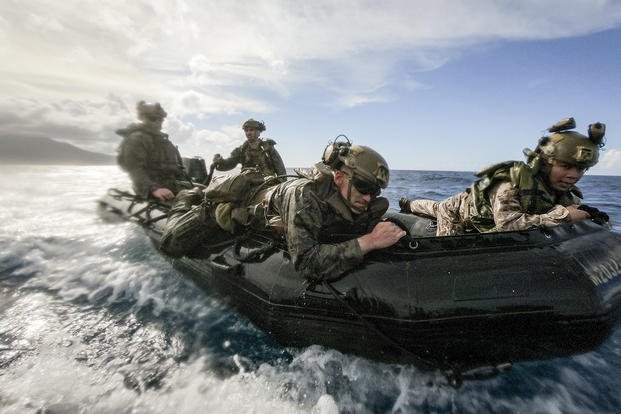 Marines hold on for a bumpy ride on a combat rubber raiding craft during a training exercise off the coast of the Philippines.