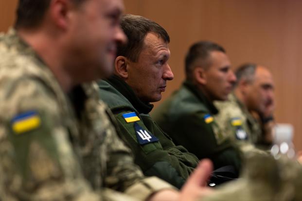 Ukrainian military members listen to U.S. Air Force airspace technicians at Ramstein Air Base.