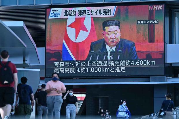 Large video screen showing images of North Korea's leader Kim Jong Un.