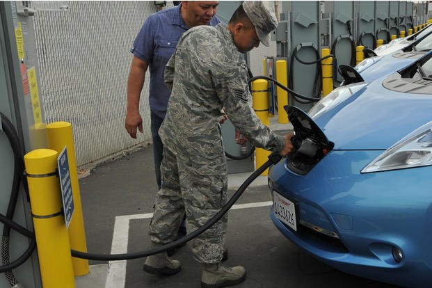 U.S. Air Force Staff Sgt. Rey Sedantes of the 61st Civil Engineering and Logistics Squadron at Los Angeles Air Force Base receives instruction on how to operate the Princeton Power Systems' bidirectional electric vehicle charging stations from vehicle operations contractor Oscar Machado during a training demo in El Segundo, Calif.