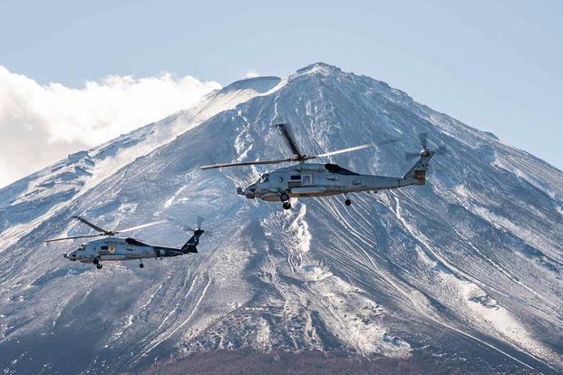 A pair of MH-60R Sea Hawks near Mount Fuji, Japan.