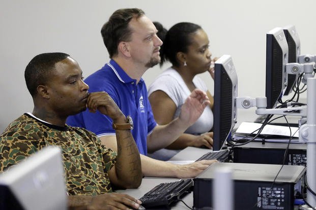 Job seekers look at their respective computer screens during a resume writing class at the Texas Workforce Solutions office in Dallas.