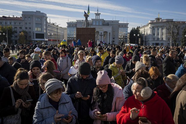 Residents gather next to an internet hotspot in Kherson, southern Ukraine, Monday, Nov. 14, 2022. (Bernat Armangue/AP Photo)