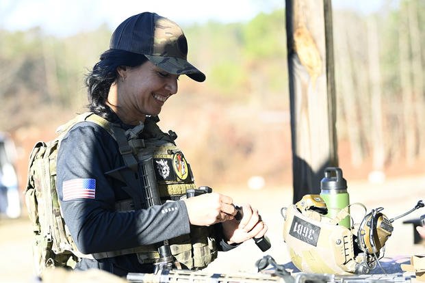 Former Congresswoman Tulsi Gabbard loads ammo before taking part in the 2021 Celebrity Tactical Challenge at the U.S. Army John F. Kennedy Special Warfare Center and School's Miller Training Complex.
