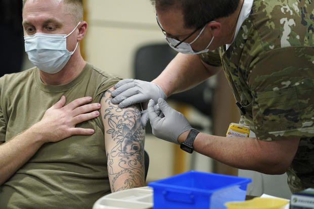 Staff Sgt. Travis Snyder first dose of the Pfizer COVID-19 vaccine.