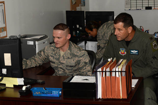 U.S. Air Force Airman 1st Class Patrick Denson, 325th Force Support Squadron force management apprentice, explains the details of his job to Col. Michael Hernandez, 325th Fighter Wing commander, at Tyndall Air Force Base, Florida.