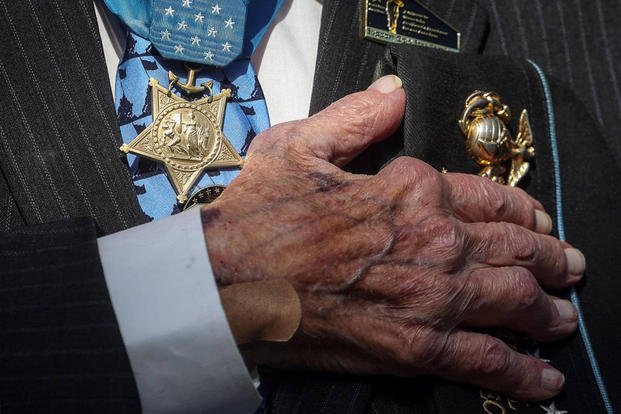 World War II veteran Hershel Woodrow Williams, a Medal of Honor recipient, puts his hand over his heart during the invocation at the National Medal of Honor Museum groundbreaking in Arlington, Texas.