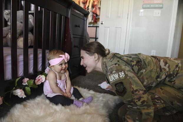 Senior airman Cierra Benak plays with her daughter.
