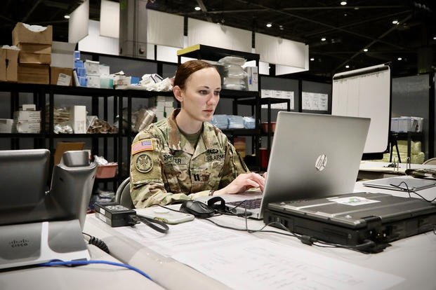 Army Capt. Kelly Spencer checks her email.