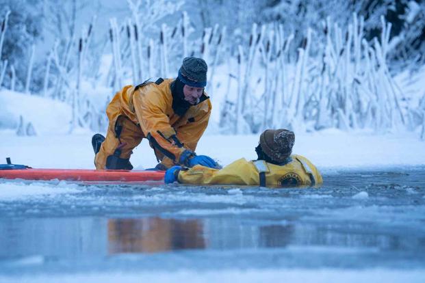 A firefighter  conducts an ice rescue in Alaska.