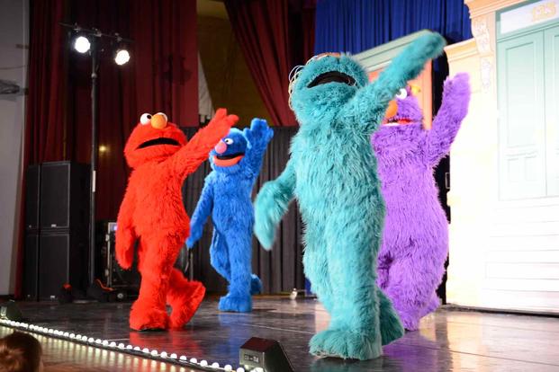 Sesame Street dance and sing at Shaw Air Force Base.