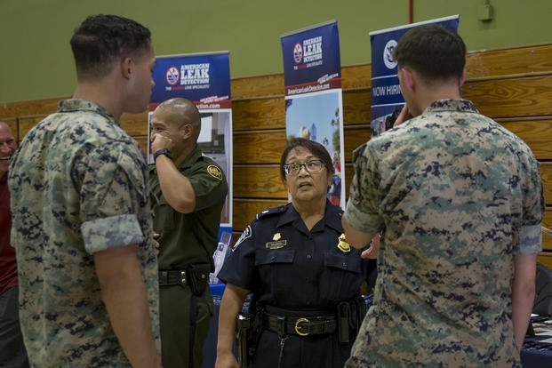 A recruiter talks to Marines about opportunities U.S. Customs and Border Protection can offer veterans during a job fair at Marine Corps Base Camp Pendleton, California.