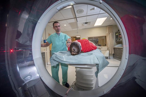Dennis Mastne, computed tomography technologist, prepares a patient for a CT scan at Brooke Army Medical Center, Fort Sam Houston, Texas,.