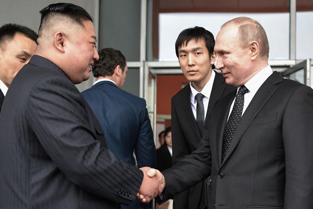 Russian President Vladimir Putin, right, sees North Korean leader Kim Jong Un off