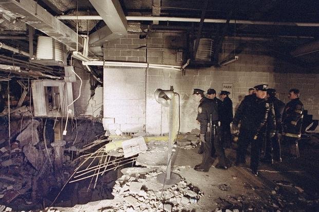 New York City police and firefighters inspect the bomb crater inside New York's World Trade Center.
