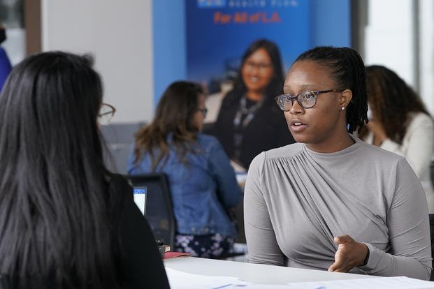 A job candidate is interviewed for a health-care customer service position at the L.A. Care Health Plan job fair.