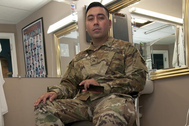 U.S. Army Reserve Sgt. Bryan Herrera surveys his workstation at one of the three barbershops he owns throughout the Richmond, Virginia, area.