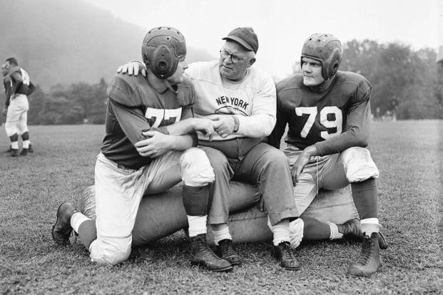 New York Giants head coach Steve Owen confers with players Jim White, left, and DeWitt ‘Tex’ Coulter during practice at Bear Mountain, New York.