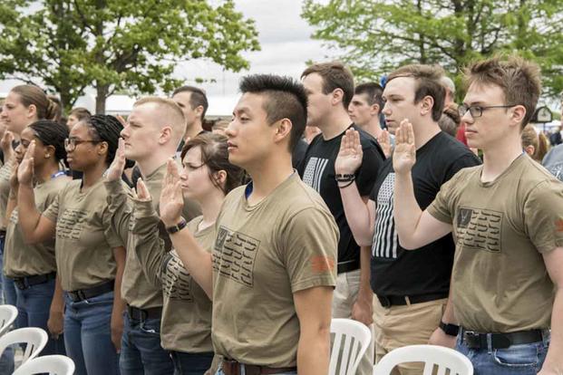 Recruits recite the oath of enlistment at the Indianapolis Motor Speedway.