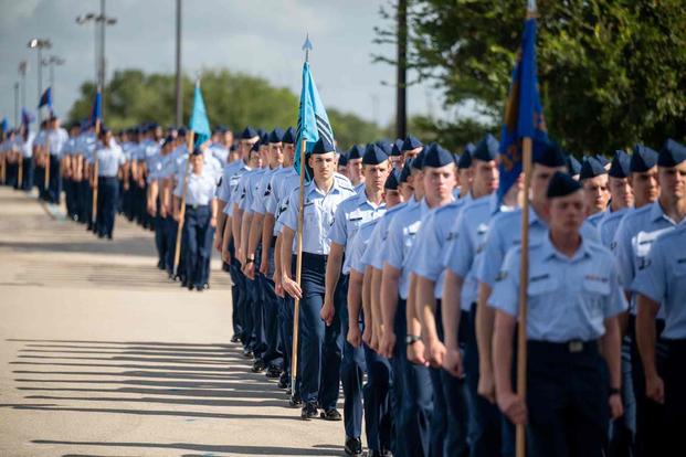 U.S. Air Force Airmen and Space Force Guardians marching.