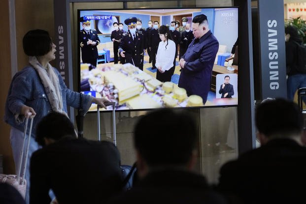 TV screen shows an image of North Korean leader Kim Jong Un, right, and his daughter