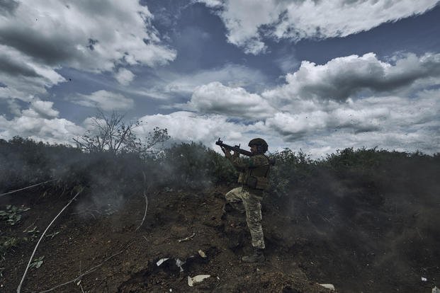A Ukrainian soldier fires an RPG toward Russian positions at the frontline near Bakhmut