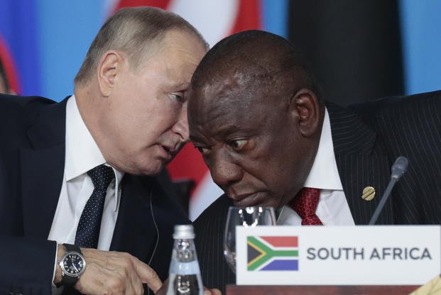 Vladimir Putin, left, speaks to South African President, Cyril Ramaphosa.