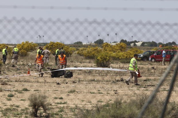 Emergency responders work in the area where an F-18 fighter jet crashed in Spain.