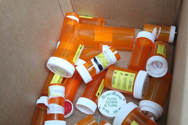 Bottles of emptied prescription drugs are tossed in a box during the Drug Take-Back event, hosted at the Marine Corps Exchange aboard Marine Corps Base Camp Lejeune, N.C.