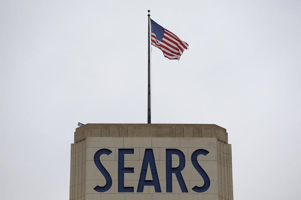 An American flag flies above a Sears department store sign in Hackensack, N.J. 