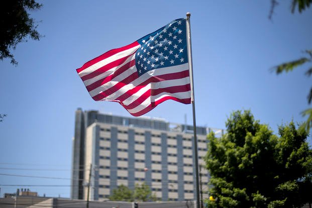 An American flag flies in front of the Atlanta VA Medical Center.