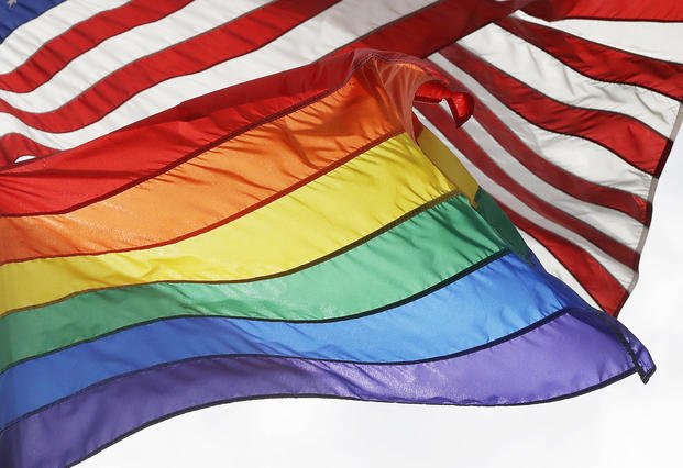 The LGBTQ+ pride flag flies.