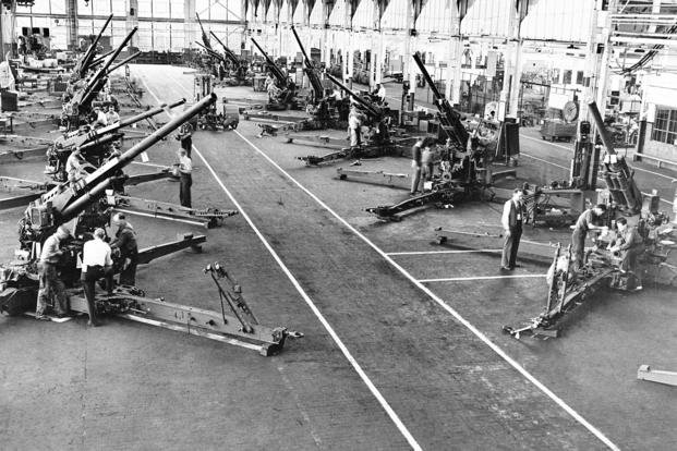 Aircraft guns, with six of them pointing skyward as they might appear in action against a high-flying enemy bomber, are shown in this view of the final assembly area at a gun plant of the Fisher Body division of General Motors, Dec. 3, 1942