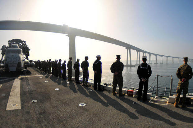 Sailors and Marines man the rails aboard the amphibious assault ship USS Boxer (LHD 4)