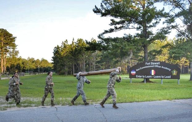 Students at a Basic Leaders Course rotation at the Noncommissioned Officer Academy on Fort Stewart, Ga., carry a log during a physical training exercise June 7, 2018, to build teamwork and comradery among their teams.