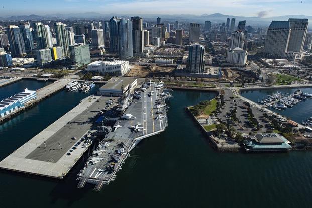 An aerial photo of the Navy Region Southwest Headquarters and USS Midway Museum in San Diego, CA. The photo was taken from a U.S. Navy MH-60S Seahawk assigned to the Helicopter Sea Combat Squadron 14 (HSC-14).