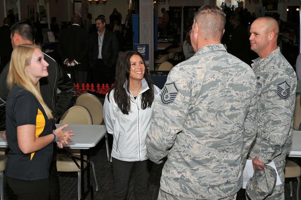Company representatives and U.S. airmen converse during a Team Shaw Job Fair at Shaw Air Force Base, South Carolina.