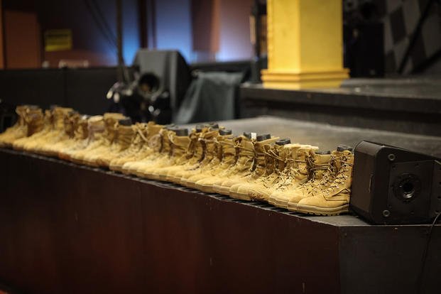 Combat boots line the stage of Beaty Theater at Fort Gregg-Adams, Virginia, during Suicide Prevention and Awareness in remembrance of service members lost to suicide. 