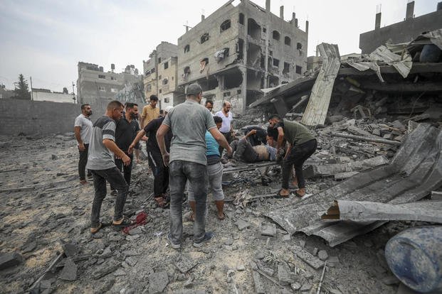 Palestinians evacuate the wounded following an Israeli aerial bombing on Jabaliya, near Gaza City