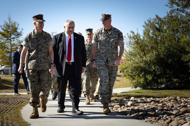 Marine Corps leadership walk toward barracks on Camp Lejeune